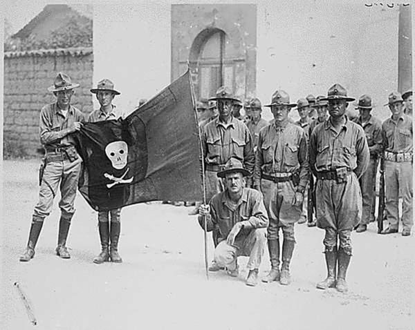 US Marines with the captured flag of Nicaragua’s Augusto Sandino in 1926