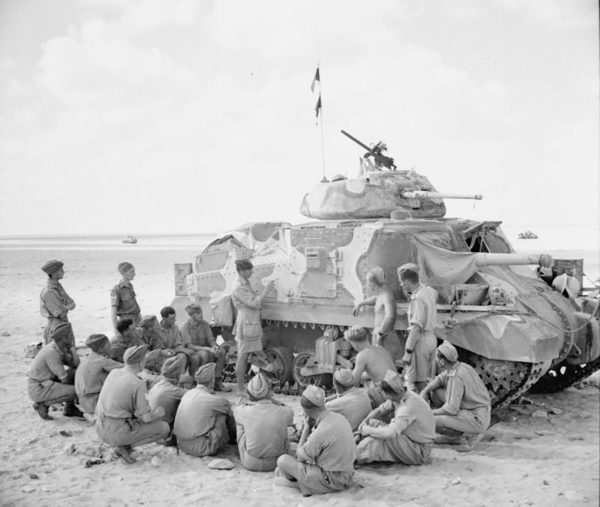 Tank crews receiving instruction on the new M3 Grant tank. This photo shows one of the camouflage patterns used by the British in the desert. 